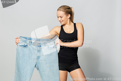 Image of young slim sporty woman with oversize pants