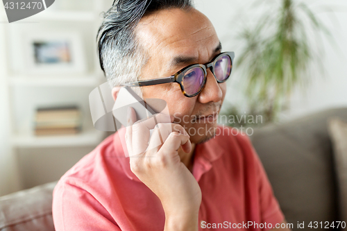 Image of close up of asian man calling on smartphone