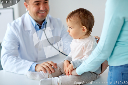 Image of doctor with stethoscope listening baby at clinic