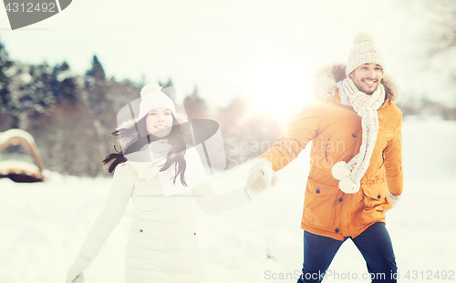 Image of happy couple walking over winter background