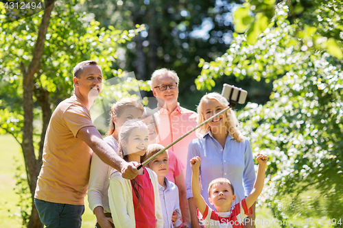 Image of happy family taking selfie in summer garden