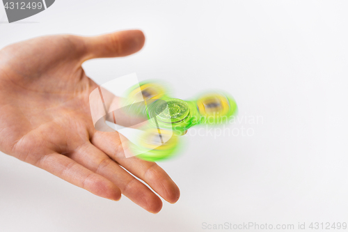 Image of close up of hand playing with fidget spinner