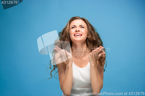 Image of Portrait of young woman with shocked facial expression