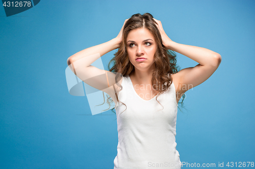 Image of Portrait of young woman with shocked facial expression