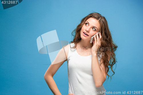 Image of Portrait of young woman with shocked facial expression