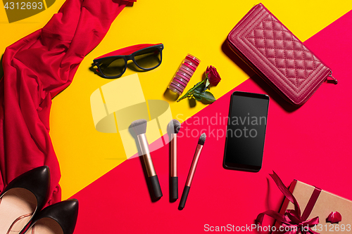 Image of Still life of fashion woman, objects on yellow table