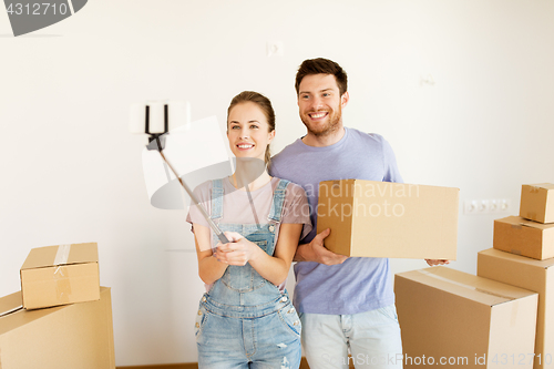 Image of happy couple with boxes moving to new home