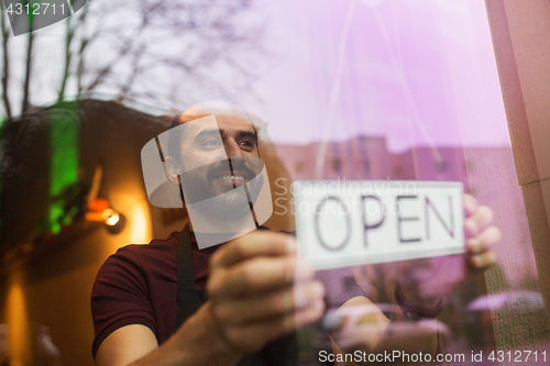 Image of man with open banner at bar or restaurant window