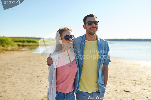 Image of happy couple hugging on summer beach