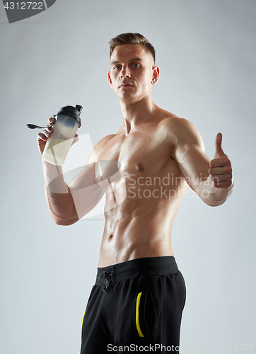 Image of bodybuilder with protein shake showing thumbs up