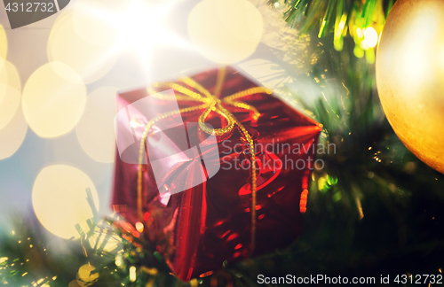 Image of close up of gift box decoration on christmas tree