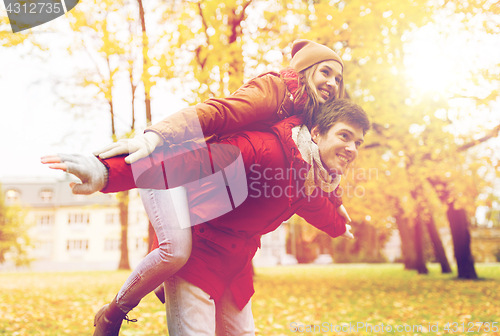 Image of happy young couple having fun in autumn park