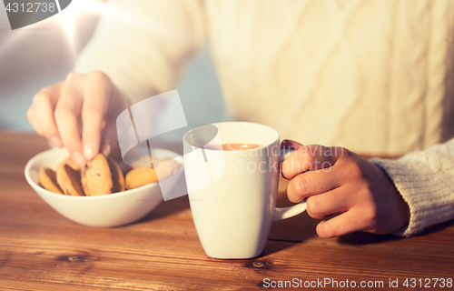 Image of close up of woman with cookies and hot chocolate