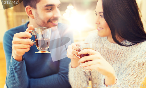 Image of happy couple drinking tea at cafe