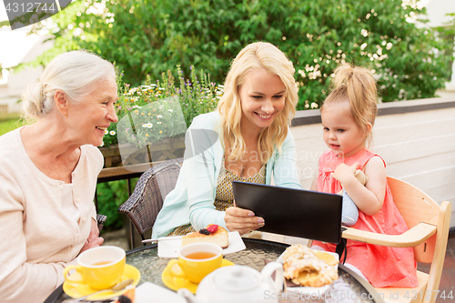 Image of mother, daughter and grandmother with tablet pc