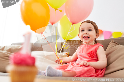 Image of happy baby girl on birthday party at home