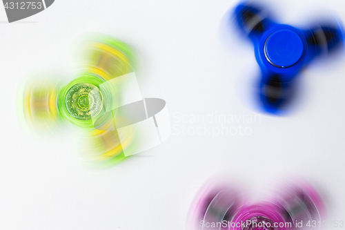 Image of spinning fidget spinners on white background
