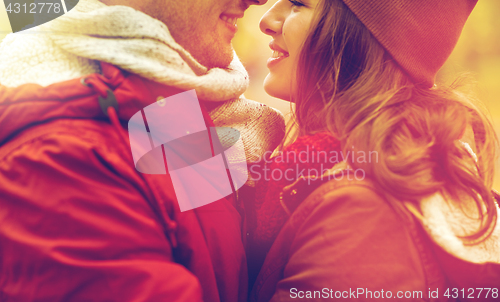 Image of close up of happy young couple kissing outdoors