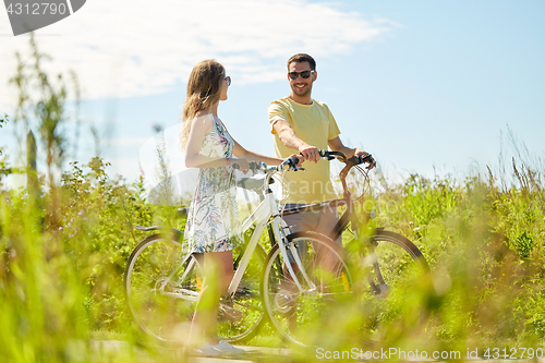 Image of happy couple with bicycles at country