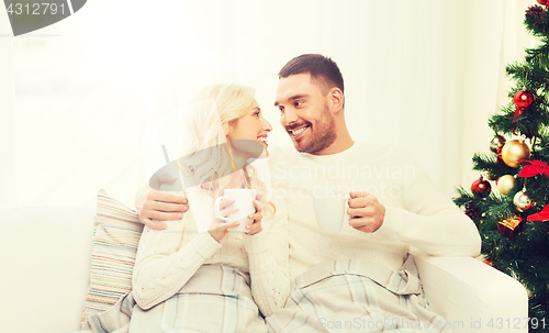 Image of happy couple at home with christmas tree