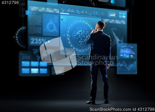 Image of businessman looking at virtual screen from back