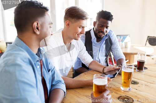 Image of male friends with tablet pc drinking beer at bar