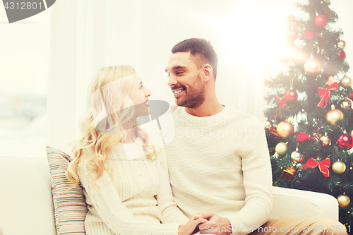 Image of happy couple at home with christmas tree