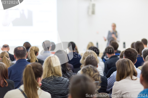 Image of Woman giving presentation on business conference.