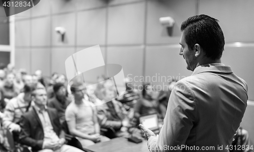 Image of Public speaker giving talk at Business Event.