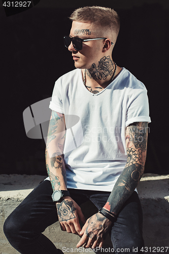 Image of Stylish young man with tattoos