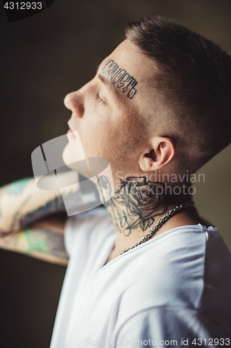 Image of Trendy young man in tattoos