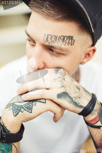 Image of Handsome man in tattoos posing