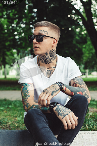 Image of Stylish young man with tattoos