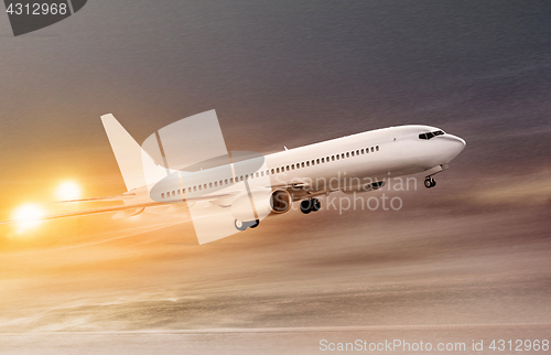 Image of airplane in snowstorm at night