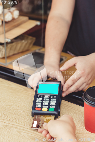 Image of Person paying bill in cafe