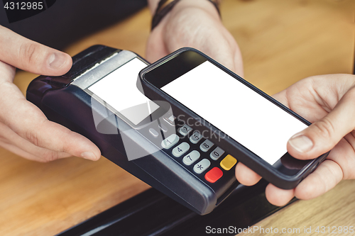 Image of Person paying pay through smartphone using NFC