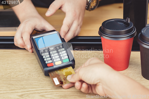 Image of Person paying bill in cafe