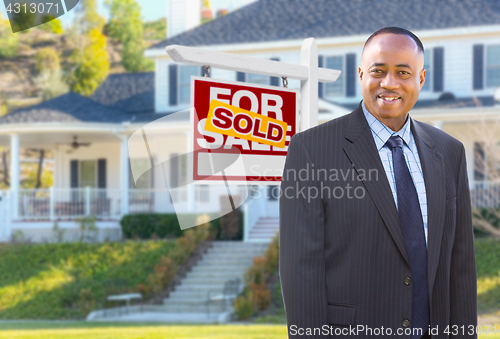 Image of African American Agent In Front of Beautiful Custom House and So