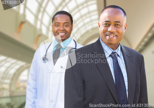 Image of African American Businessman and Doctor Inside Medical Building.