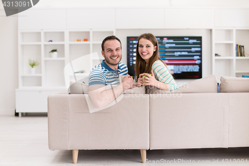 Image of young handsome couple enjoying morning coffee