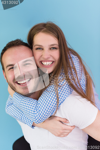 Image of young man piggybacking his girlfriend