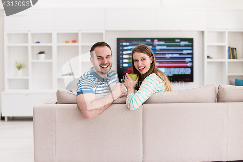 Image of young handsome couple enjoying morning coffee