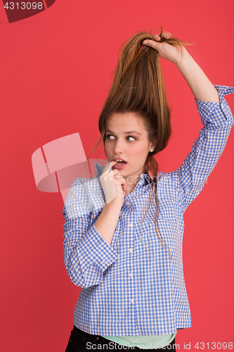 Image of woman playing with her long silky hair