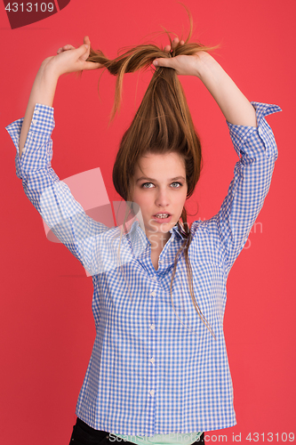 Image of woman playing with her long silky hair