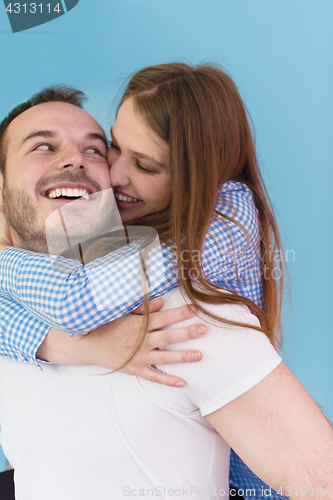 Image of young man piggybacking his girlfriend