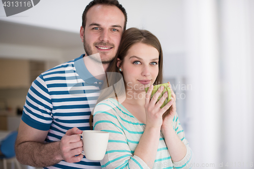 Image of young handsome couple enjoying morning coffee