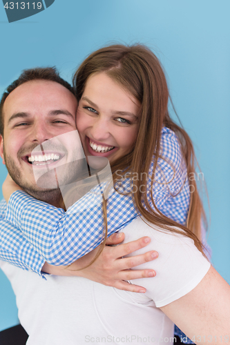 Image of young man piggybacking his girlfriend