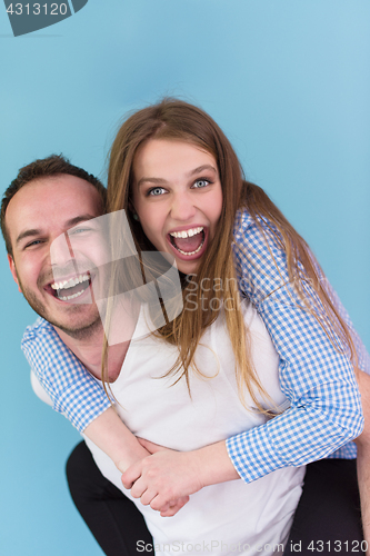 Image of young man piggybacking his girlfriend