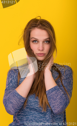 Image of pretty woman playing with her long silky hair