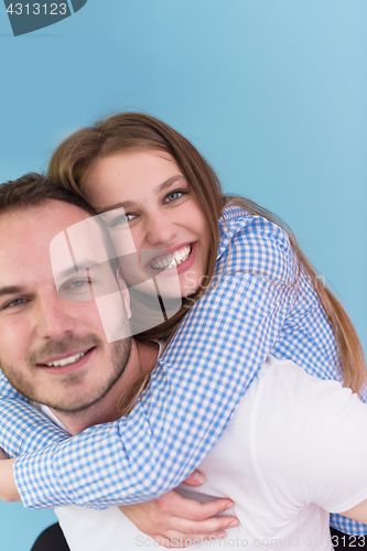 Image of young man piggybacking his girlfriend